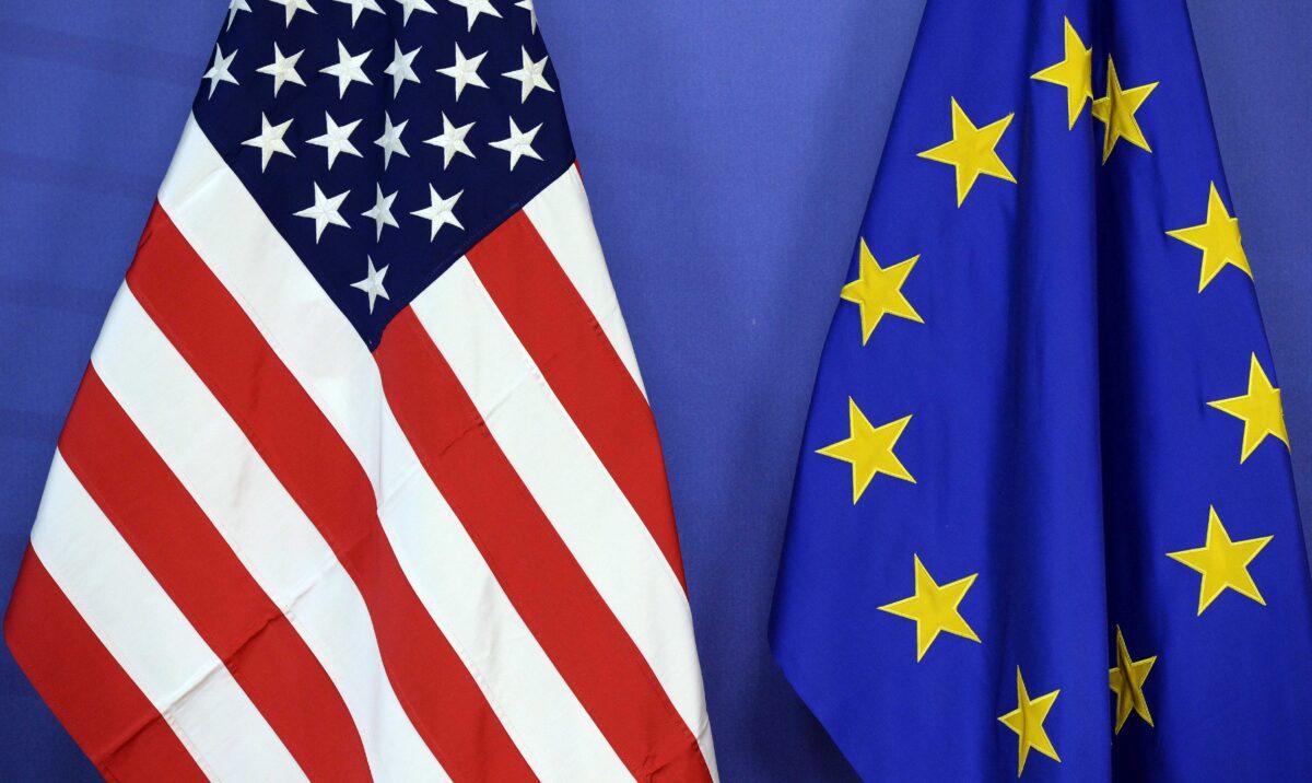 The U.S. national flag (L) and the European Union flag are seen side-by-side during a meeting at the EU Commission headquarters in Brussels on July 13, 2015. (Thierry Charlier/AFP via Getty Images)