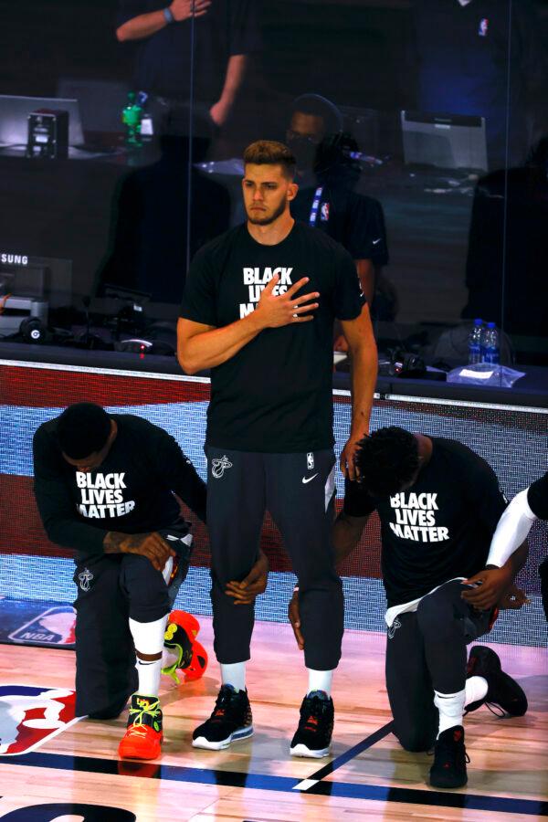 Miami Heat's Meyers Leonard stands during the national anthem before an NBA basketball game against the Denver Nuggets, Saturday, Aug. 1, 2020, in Lake Buena Vista, Fla. (Kevin C. Cox/Pool Photo via AP)