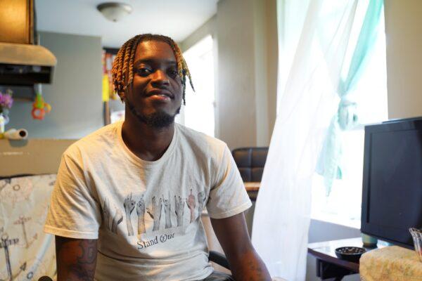 Paris Brown sits in his apartment in Chicago on July 20, 2020. (Cara Ding/The Epoch Times)