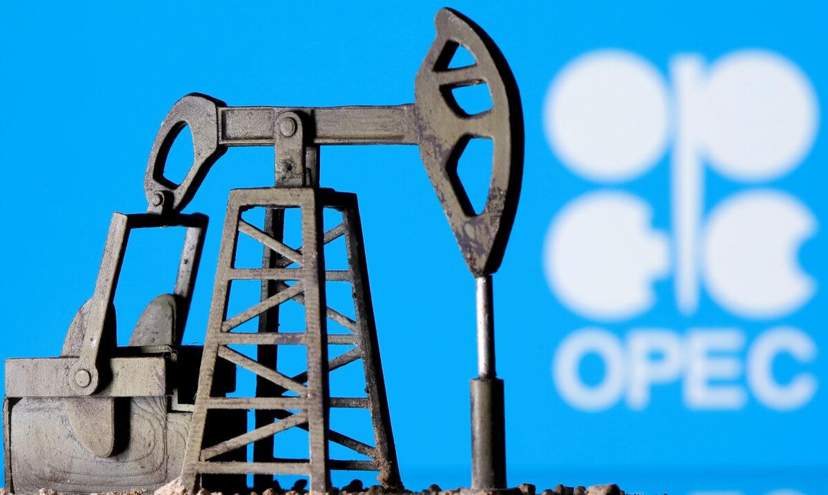 A 3D printed oil pump jack is seen in front of the displayed OPEC logo in this illustration picture, on April 14, 2020. (Dado Ruvic/Illustration/Reuters)