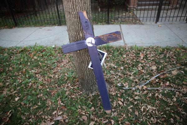 A cross sits on a sidewalk in the Austin neighborhood of Chicago on Nov. 18, 2016, near the spot where a 29-year-old man was shot and killed the day before. Gun-related homicides spiked in Chicago in 2016, and 2020 is on course for a similar spike. (Scott Olson/Getty Images)