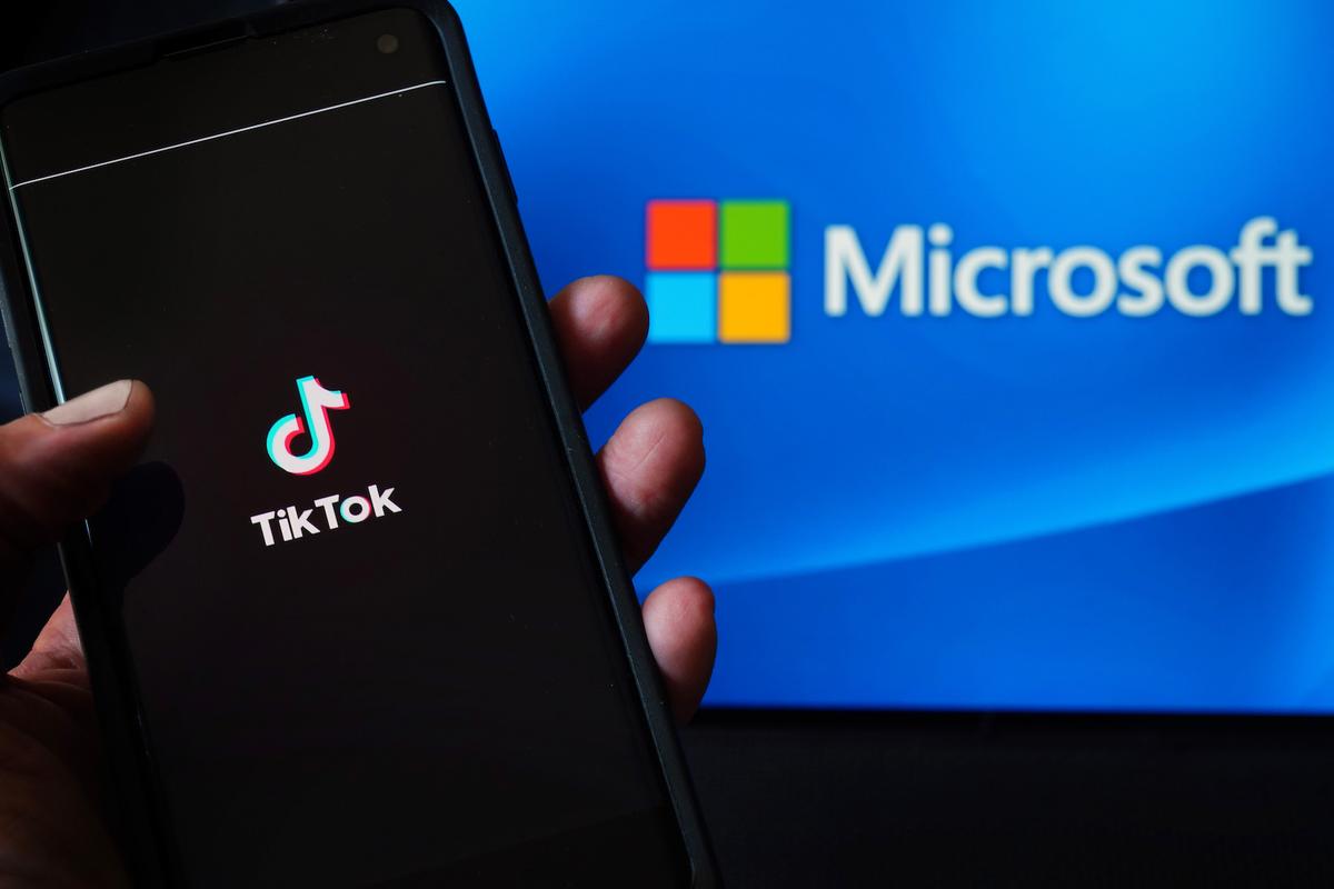  In this photo illustration, a mobile phone featuring the TikTok app is displayed next to the Microsoft logo in New York City on Aug. 3, 2020. (Cindy Ord/Getty Images)