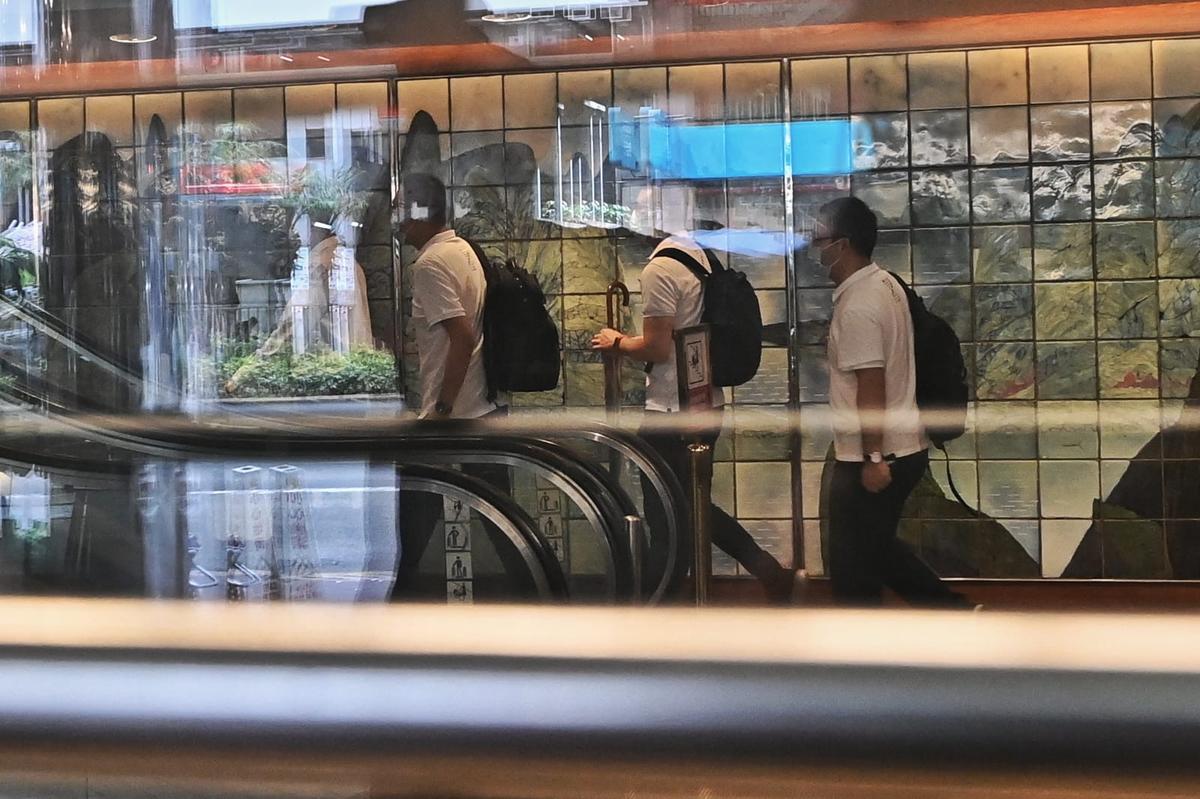 Seven medical workers sent from China check into Metropark Hotel Kowloon on Aug. 3, 2020. (Song Bilong/The Epoch Times)