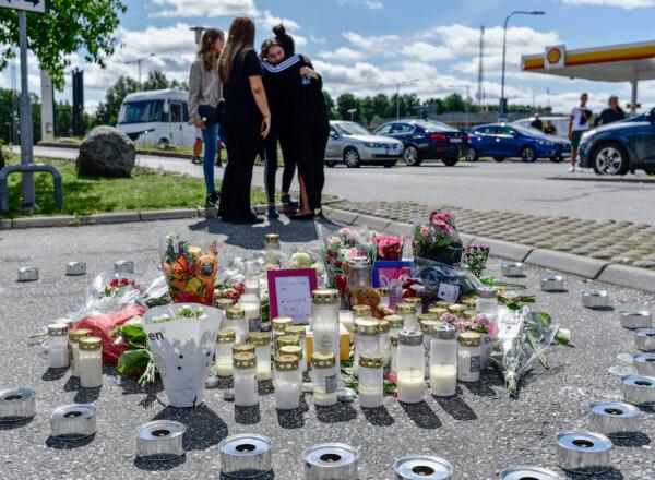 <span style="font-family: 'Verdana',sans-serif; color: #2c2c2c;">People gather near to where a 12-year-old girl was shot and killed near a petrol station in Botkyrka, south of Stockholm, Sweden, on Aug. 3, 2020. (Stina Stjernkvist/TT via AP Photo)</span>