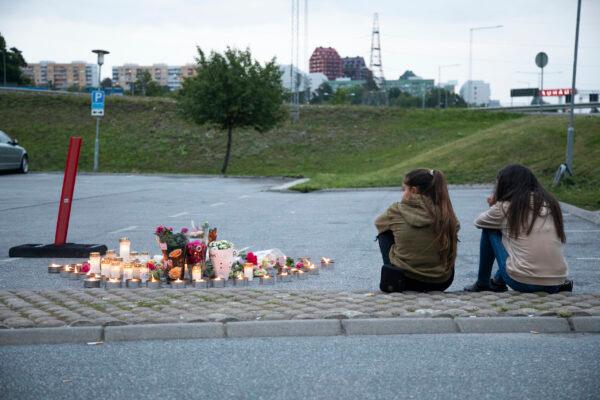 <span style="font-family: 'Verdana',sans-serif; color: #2c2c2c;">Flowers and candles are placed near where a 12-year-old girl was shot and killed near a petrol station in Botkyrka, south of Stockholm, Sweden, on Aug. 2, 2020. (Ali Lorestani//TT via AP Photo)</span>