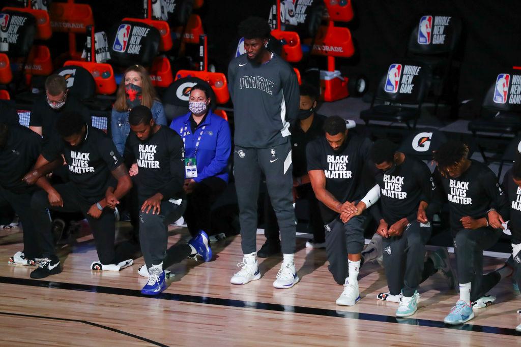 Jonathan Isaac stands as others kneel during the National Anthem before a game against the Sacramento Kings at HP Field House in Lake Buena Vista, Fla., on Aug. 2, 2020. (Kim Klement-Pool/Getty Images)