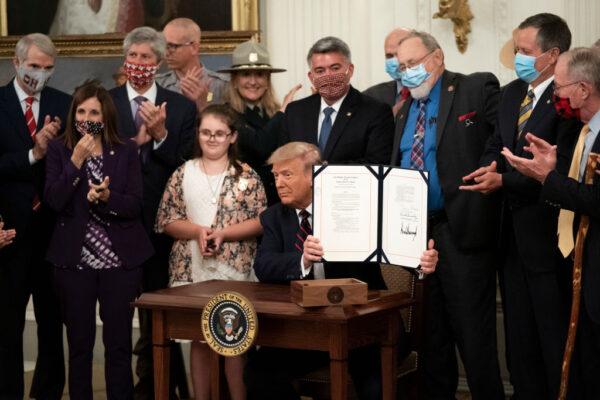 President Donald Trump signs the Great American Outdoors Act at the White House in August 2020, which aims to upgrade federal public lands funding, including for national parks, and to permanently fund The Land and Water Conservation Fund. (Photo by Drew Angerer/Getty Images)