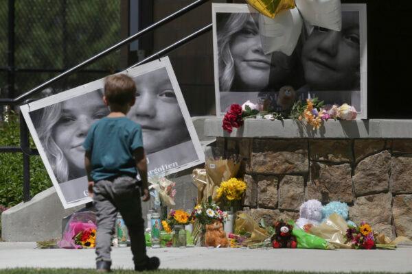 A boy looks at a memorial for Tylee Ryan, 17, and Joshua "JJ" Vallow, 7, at Porter Park in Rexburg, Idaho, on June 11, 2020. (John Roark/The Idaho Post-Register via AP, File)