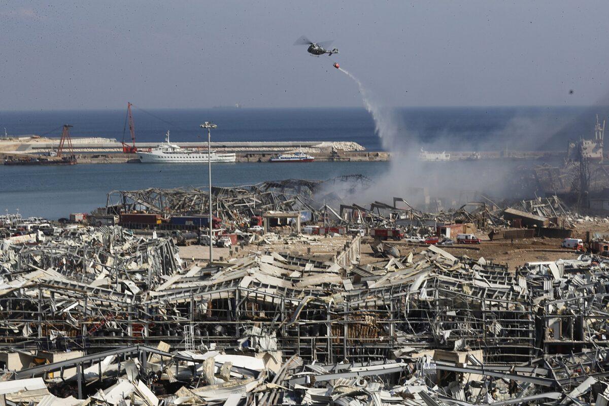 A Lebanese army helicopter throw water at the scene where an explosion hit the seaport of Beirut, Lebanon on Aug. 5, 2020. (Hussein Malla/AP Photo)