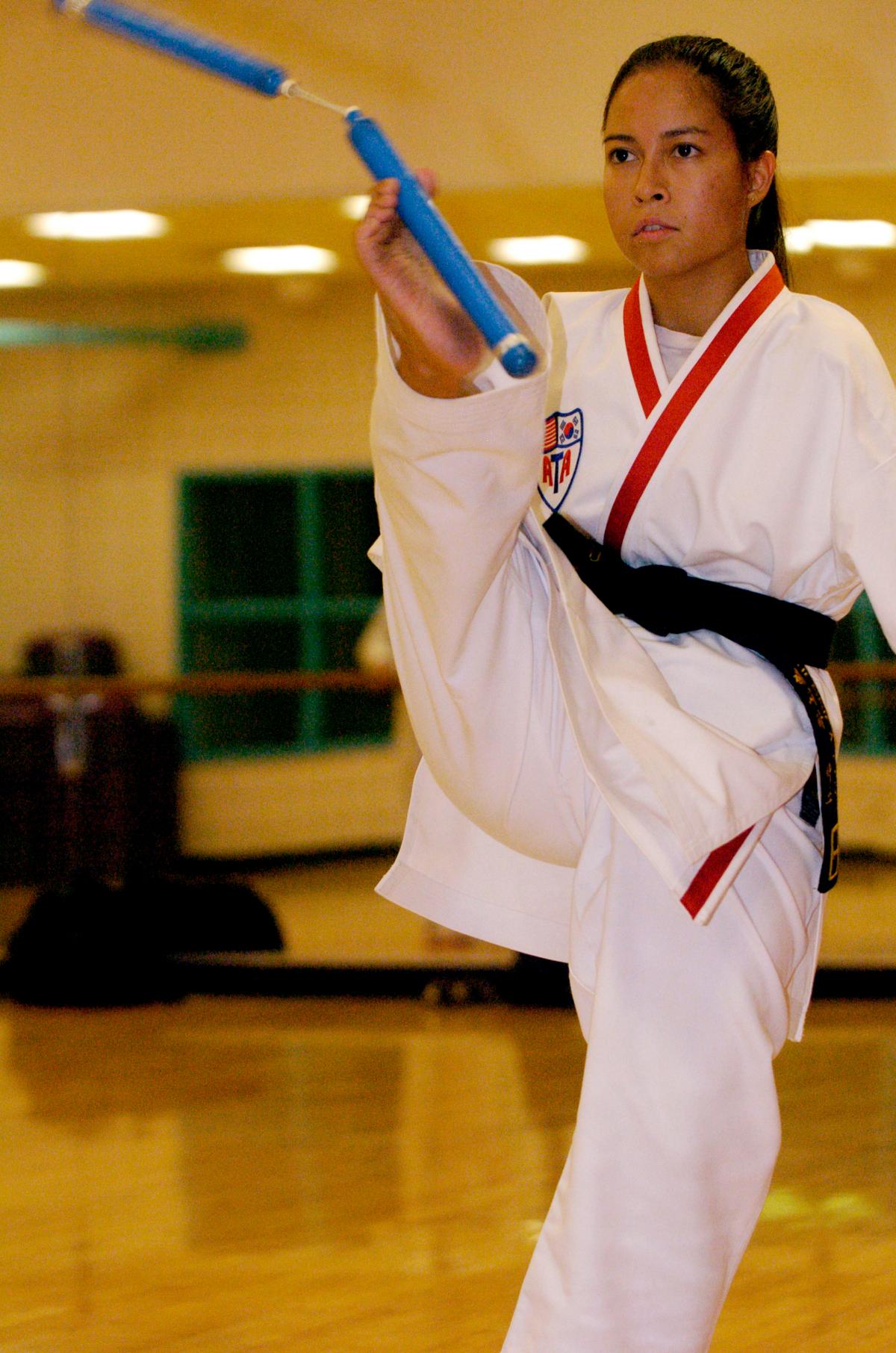 Jessica using nunchucks while practicing Tae Kwon Do (Courtesy of <a href="https://www.jessicacox.com/">Jessica Cox</a>)