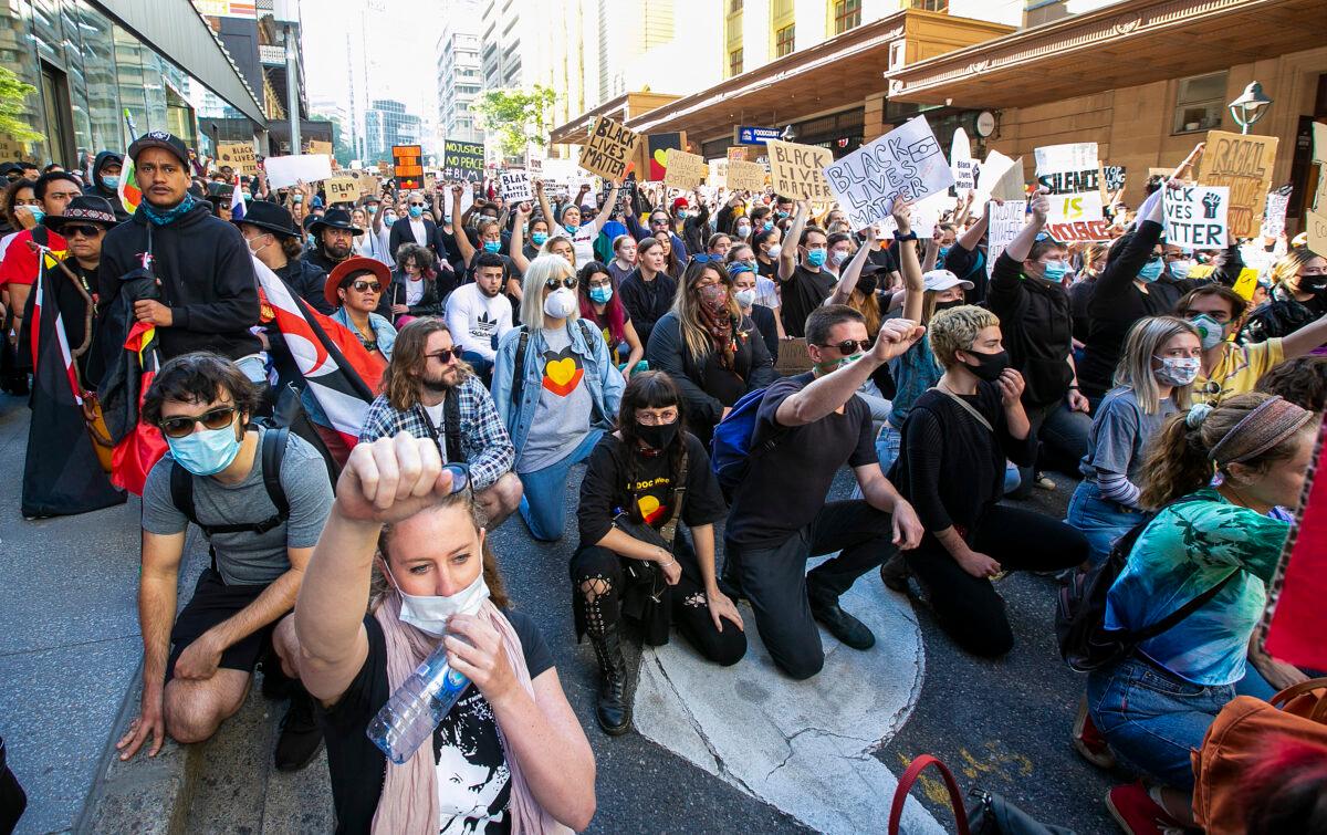 People kneel in the CBD in Brisbane, Australia on June 06, 2020. (Jono Searle/Getty Images)
