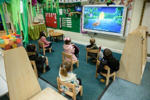 Nursery children sit apart from each other to minimise the risk of passing on Coronavirus at Willowpark Primary Academy in Oldham, north-west England on June 18, 2020. (Oli Scarff/AFP via Getty Images)