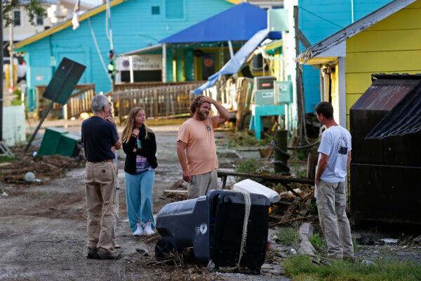 Residents survey the damages along the waterfront following the effects of Hurricane Isaias in Southport, N.C. on Aug. 4, 2020. (AP Photo/Gerry Broome)