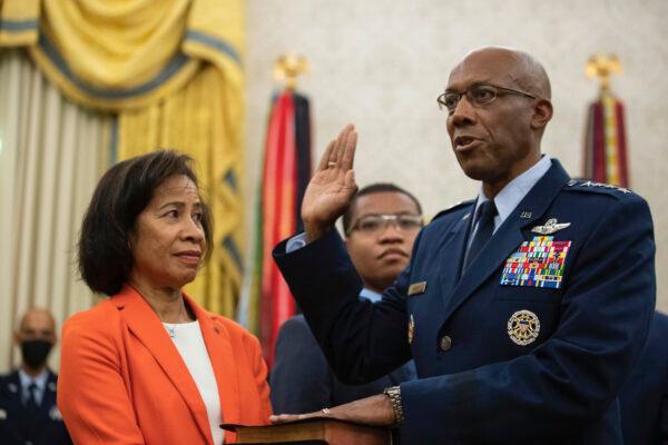 Gen. Charles Q. Brown Jr. is sworn is as chief of staff of the Air Force as his wife, Sharene Guilford Brown, holds a Bible, in the Oval Office of the White House on Aug. 4, 2020. (AP Photo/Alex Brandon)
