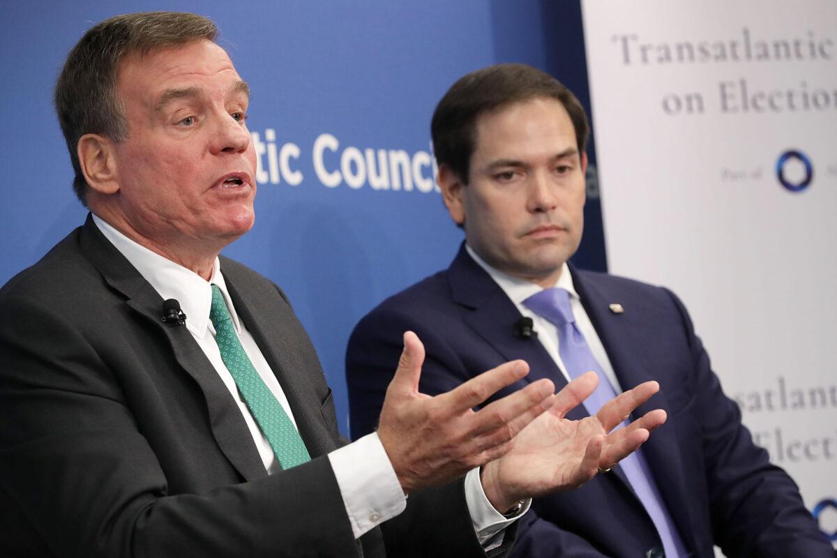 Sens. Mark Warner (D-Va.) (L) and Marco Rubio (R-Fla.), both members of the Senate Intelligence Committee, participate in a discussion at the Atlantic Council in Washington on July 16, 2018. (Chip Somodevilla/Getty Images)
