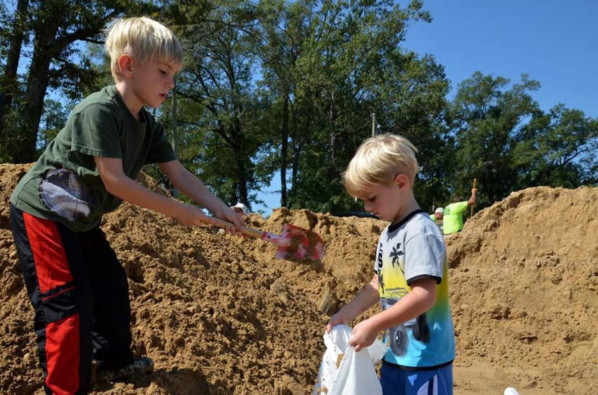 [L-R] Greyson volunteers with his brother Garrett. (Courtesy of Stevie Winfield)