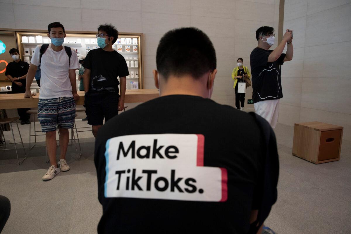 A man wearing a shirt promoting TikTok is seen at an Apple store in Beijing, China, on July 17, 2020. (Ng Han Guan/AP Photo)