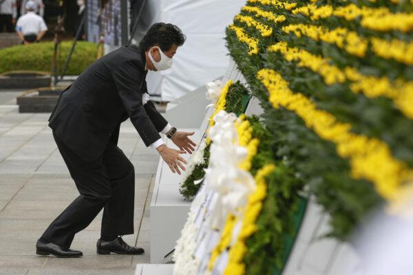 Japan's Prime Minister Shinzo Abe offers a wreath to the cenotaph for the victims of the 1945 atomic bombing, at Peace Memorial Park in Hiroshima, western Japan on Aug. 6, 2020. (Kyodo/via Reuters)