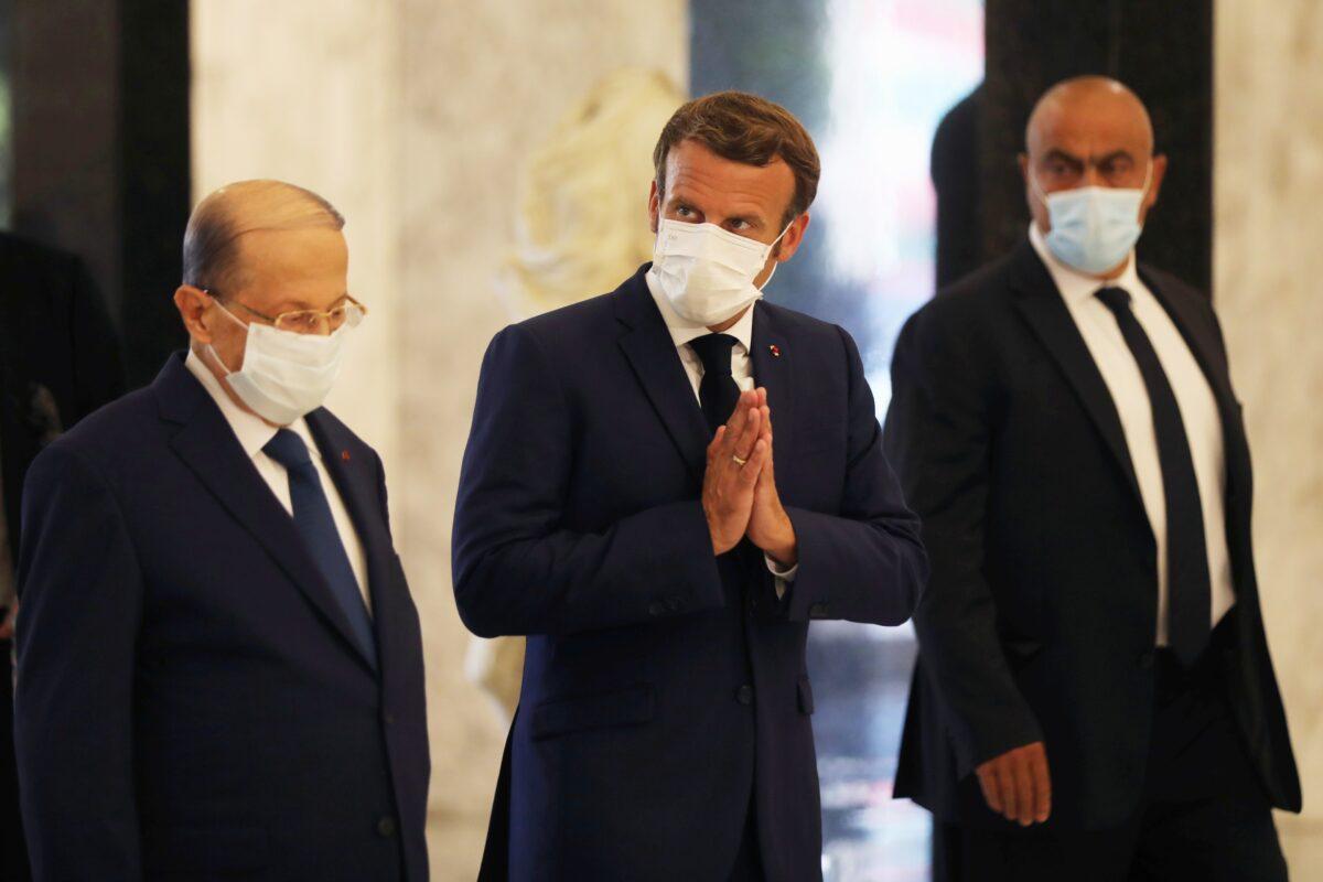 French President Emmanuel Macron and Lebanon's President Michel Aoun wear protective face masks as they meet following Tuesday's blast in Beirut's port area, at the presidential palace in Baabda, Lebanon, on Aug. 6, 2020. (Mohamed Azakir/Reuters)