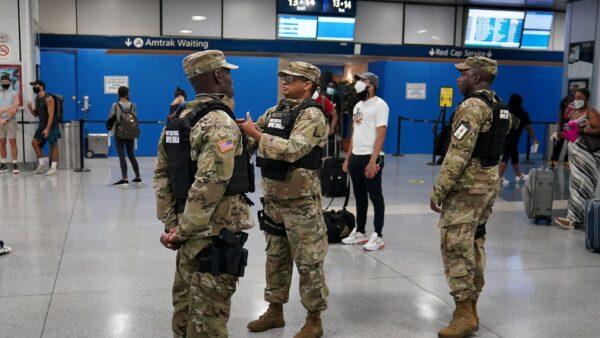 Military officials stand during an effort to screen out-of-state travelers at Penn Station in New York City, on August 6, 2020. (Carlo Allegri/Reuters)