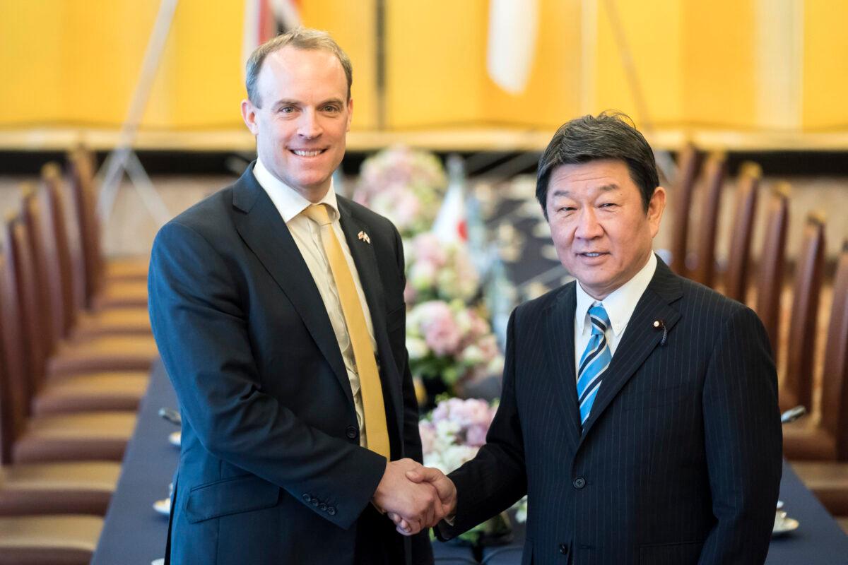UK Foreign Secretary Dominic Raab (L) and Japan's Foreign Minister Toshimitsu Motegi shake hands as they arrive for the eighth Japan-UK Foreign Ministers' Strategic Dialogue at Iikura Guest House in Tokyo, Japan, on Feb. 8, 2020. (Tomohiro Ohsumi/Getty Images)