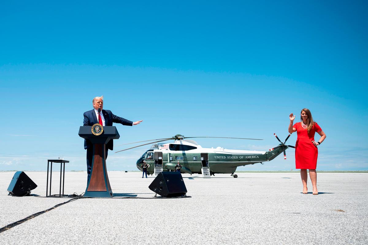 President Donald Trump points to Christina Hagan, Candidate for U.S. representative from Ohio's 13th Congressional District, as he speaks on economic prosperity, at Burke Lakefront Airport in Cleveland, Ohio, on Aug. 6, 2020. (Jim Watson/AFP via Getty Images)