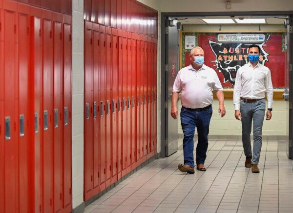 Ontario Premier Doug Ford and Education Minister Stephen Lecce walk along a hallway at Father Leo J. Austin Catholic Secondary School before making an announcement on the government’s plan for a safe reopening of schools in the fall, in Whitby, Ont., on July 30, 2020. (The Canadian Press/Nathan Denette)