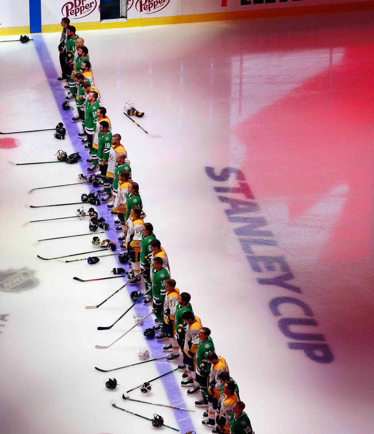 The Dallas Stars and the Nashville Predators stand at attention during the national anthem prior to their exhibition game before the 2020 NHL Stanley Cup Playoffs at Rogers Place on July 30, 2020, in Edmonton, Canada. (Jeff Vinnick/Getty Images)