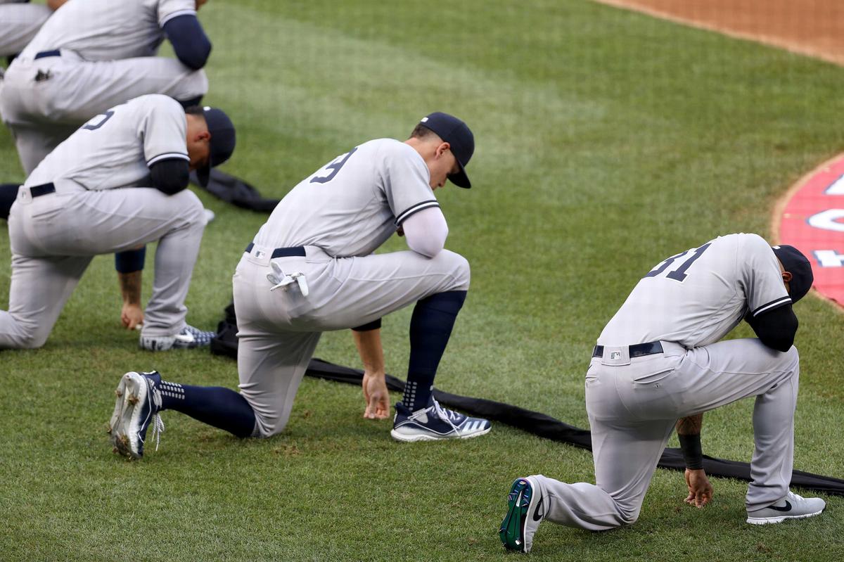 The New York Yankees kneel during a moment of silence prior to the game against the Washington Nationals at Nationals Park on July 23, 2020, in Washington. (Rob Carr/Getty Images)
