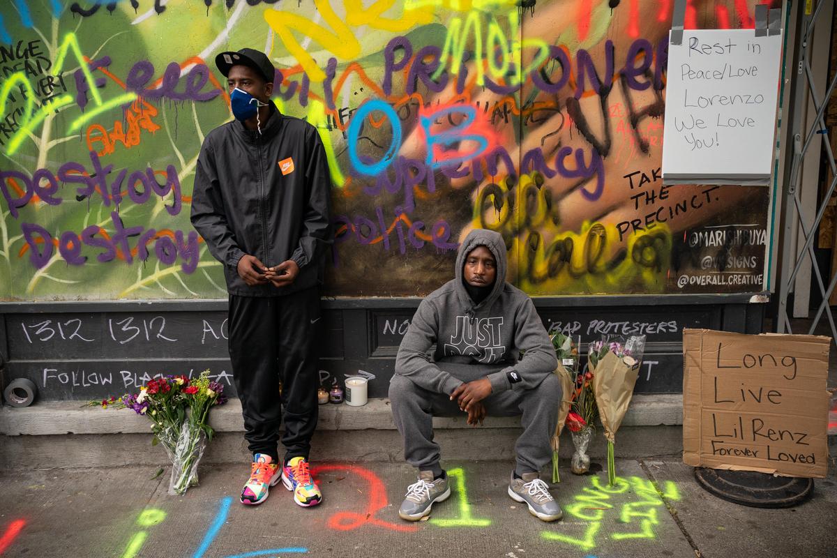 TJ Jenkins and Derel Jenkins pay their respects at a memorial near the site of where their cousin, Lorenzo Anderson, was shot dead, in the so-called CHOP area in Seattle, Wash., on June 20, 2020. (David Ryder/Getty Images)