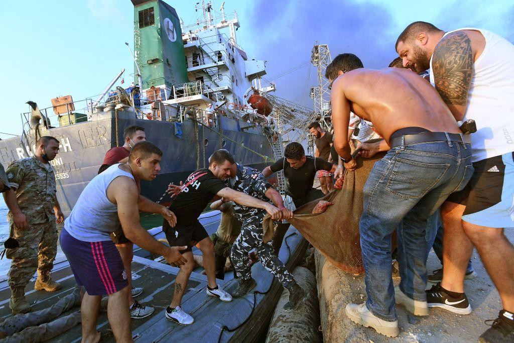 A wounded man is evacuated from a boat following an explosion at the port of the Lebanese capital Beirut on Aug. 4, 2020. (AFP via Getty Images)