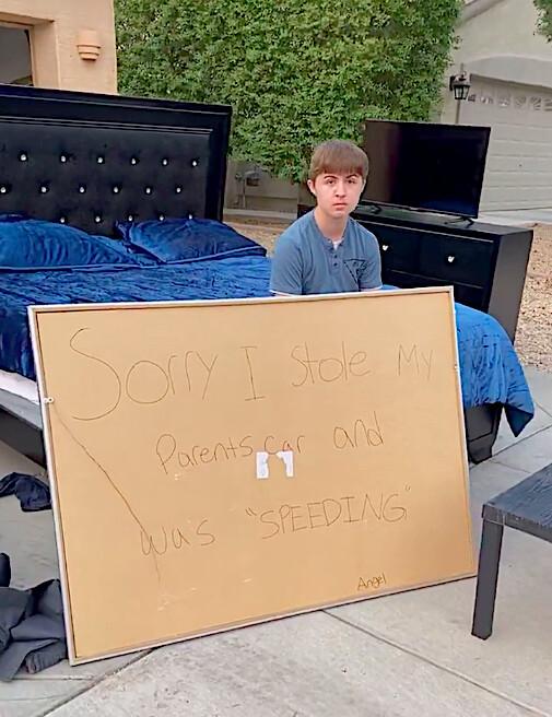 Angel Martinez, 14, sits with his handwritten sign as his belongings are given away. (Courtesy of <a href="https://www.facebook.com/ramoncitorams1">Ramon Martinez</a>)