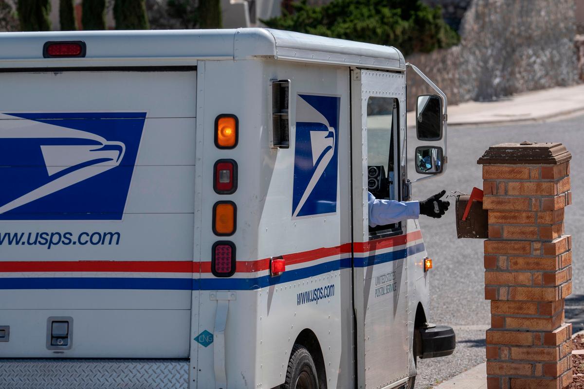 United States Postal Service mail carrier Frank Colon, 59, delivers mail amid the CCP virus pandemic in El Paso, Texas, on April 30, 2020. (Paul Ratje/AFP via Getty Images)