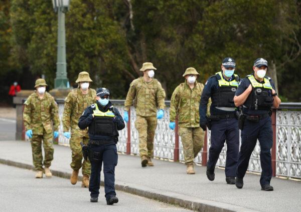 Police and the Australian military patrol the banks of the Yarra River in Melbourne, Australia, on July 23, 2020. (Robert Cianflone/Getty Images)