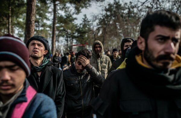 Migrants wait in the buffer zone near the Pazarkule crossing gate in Edirne at the Turkey-Greece border on March 5, 2020. (Bulent Kilic/AFP via Getty Images)
