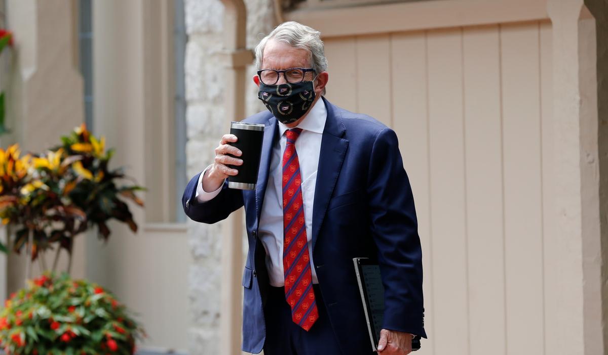 Ohio Gov. Mike DeWine acknowledges members of the media while entering his residence after testing positive for COVID-19 earlier in the day in Bexley, Ohio, on Aug. 6, 2020. (Jay LaPrete/AP photo)