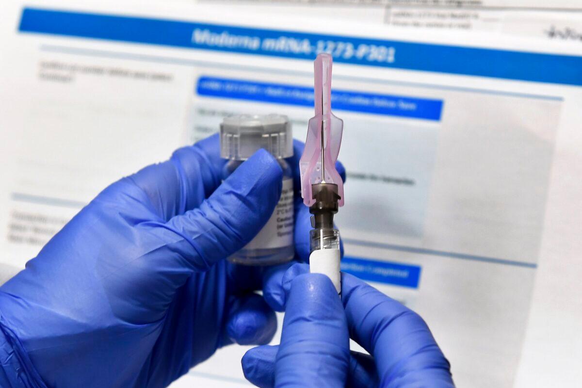 A nurse prepares a shot as a study of a possible COVID-19 vaccine, developed by the National Institutes of Health and Moderna Inc., gets underway in Binghamton, N.Y., on July 27, 2020. (Hans Pennink/AP Photo)