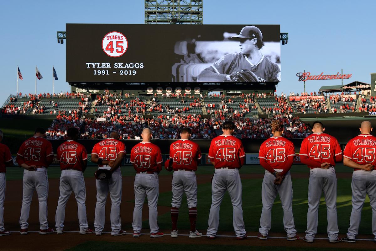 The Los Angeles Angels of Anaheim stand for a moment of silence, wearing #45 on their jersey to commemorate Tyler Skaggs, at Angel Stadium of Anaheim in Anaheim, Calif., on July 12, 2019. (John McCoy/Getty Images)