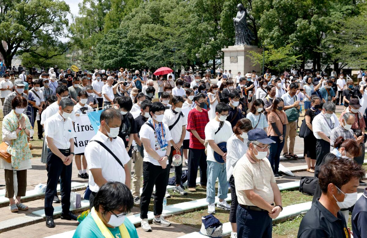 People offer silent prayer for the victims of U.S. atomic bombing at the time when the bomb was dropped, at the Atomic Bomb Hypocenter Park in Nagasaki, southern Japan, on Aug. 9, 2020. (Takuto Kaneko/Kyodo News via AP)