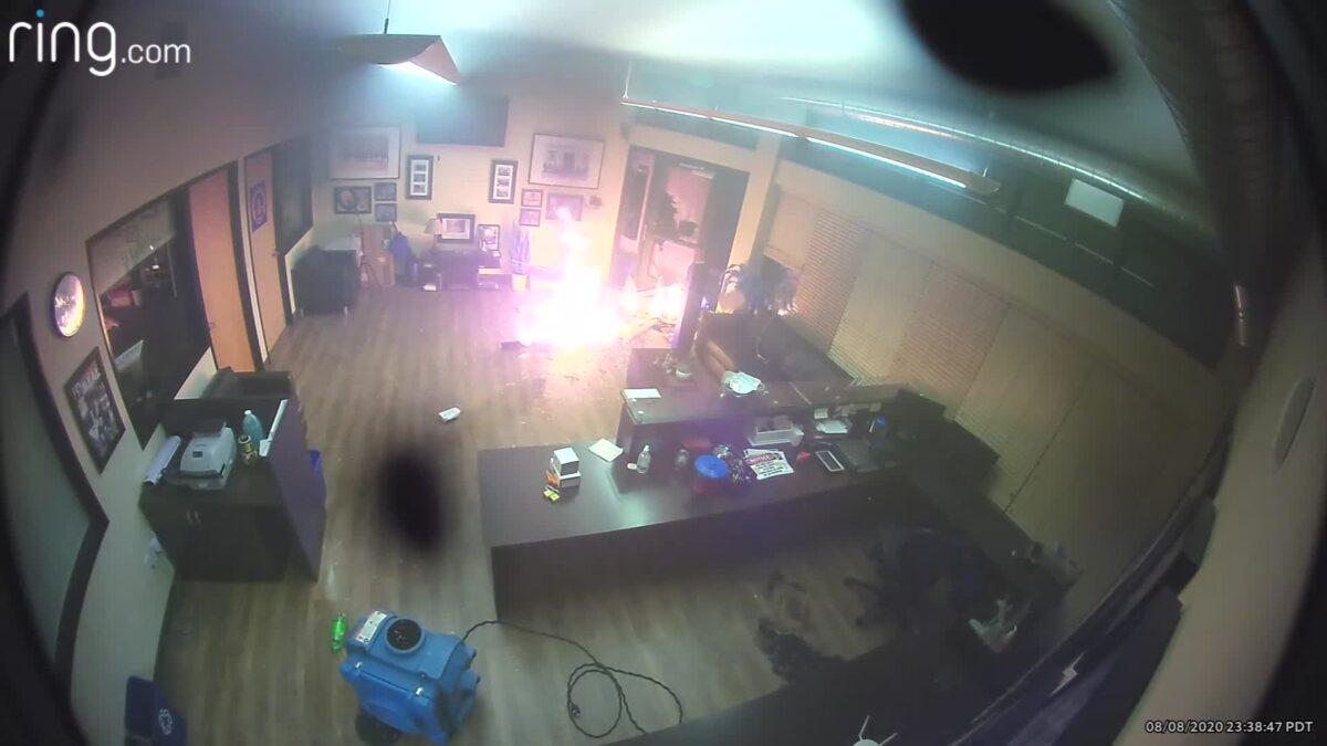 Security video from inside a Portland Police Association office shows unidentified people tossing flaming debris inside on Aug. 8. 2020. (Portland Police Association)
