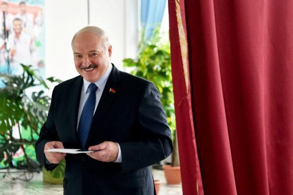 Belarusian President Alexander Lukashenko reacts as he visits a polling station during the presidential election in Minsk, Belarus Aug. 9, 2020. (Sergei Gapon/Pool via Reuters)