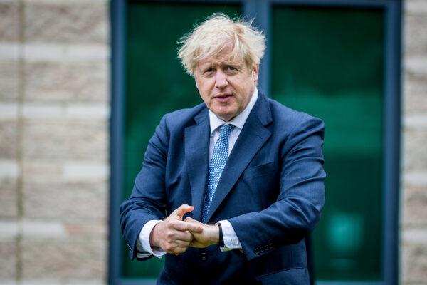 British Prime Minster Boris Johnson applies hand sanitiser during a visit to North Yorkshire Police to meet with recently graduated police officers in Northallerton, United Kingdom, on July 30, 2020. (Charlotte Graham/Reuters)