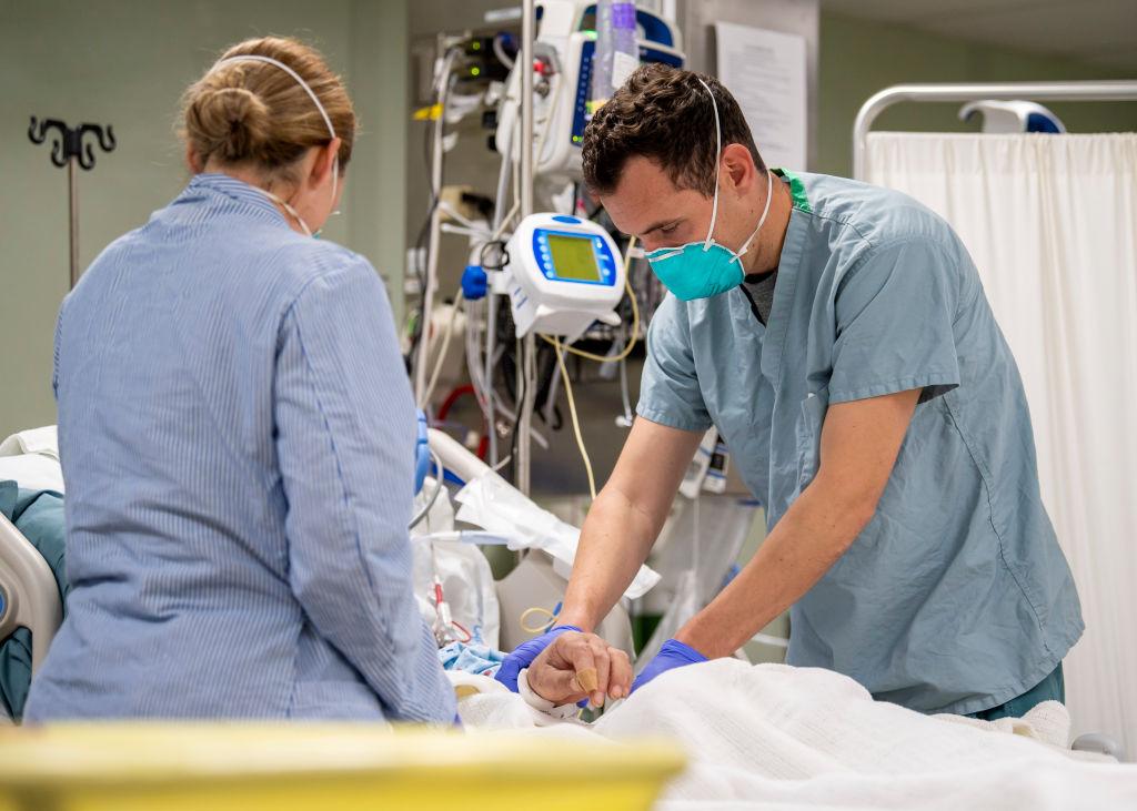 In this handout released by the U.S. Navy, Lt. Wade Miller, from Orlando, Florida, treats a patient aboard the hospital ship USNS Mercy (T-AH 19) in Los Angeles, California on April 4, 2020. (Ryan M. Breeden/US Navy via Getty Images)