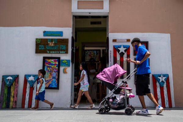 Pedestrians on a street in Old San Juan, Puerto Rico, on July 20, 2020. (Ricardo Arduengo/AFP via Getty Images)