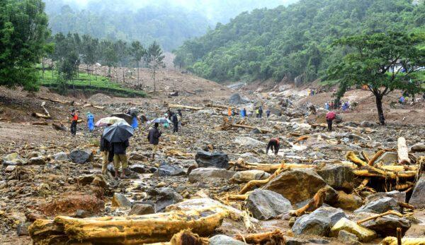 Volunteers, local residents and members of National Disaster Response Force (NDRF) search for survivors in the debris left by a landslide at Puthumala at Meppadi in the Wayanad district of the Indian state of Kerala on Aug. 10. (STR/AFP via Getty Images)