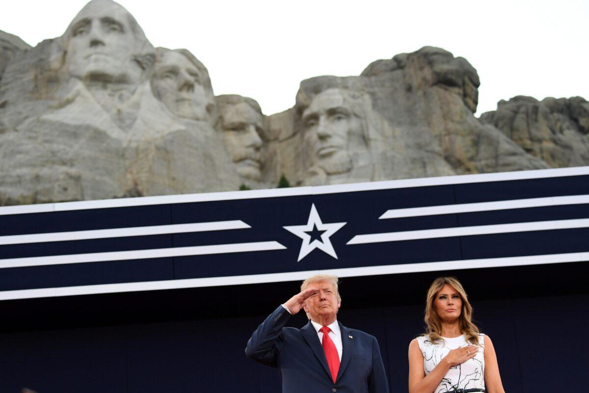 President Donald Trump and First Lady Melania Trump pay their respects as they listen to the National Anthem during the Independence Day events at Mount Rushmore National Memorial in Keystone, S.D., on July 3, 2020. (Saul Loeb/AFP/Getty Images)