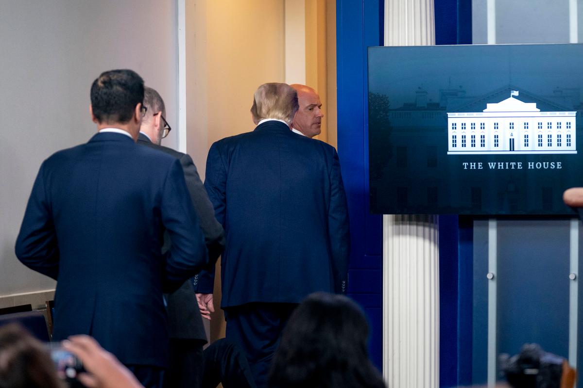 President Donald Trump is asked to leave the James Brady Press Briefing Room by a member of the U.S. Secret Service during a news conference at the White House, on Aug. 10, 2020. (Andrew Harnik/AP Photo)