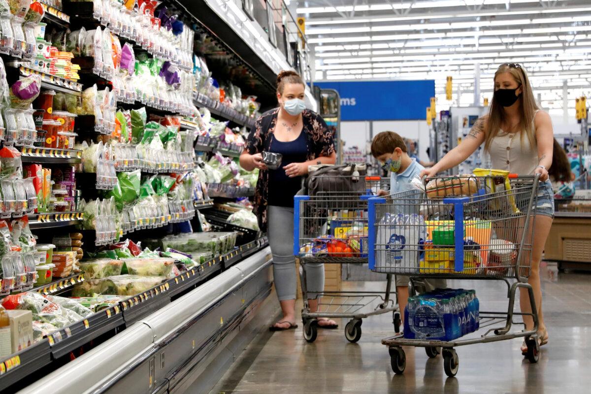 A family wears masks while shopping at a Walmart store in Bradford, Pa., on July 20, 2020. (Brendan McDermid/Reuters)