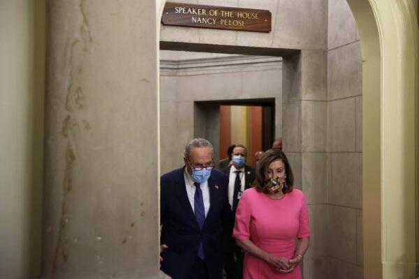 (L) Senate Minority Leader Chuck Schumer (D-N.Y.) and House Speaker Nancy Pelosi (D-Calif.) walk to speak to reporters after meeting with White House officials at the U.S. Capitol in Washington on Aug. 7, 2020. (Alex Wong/Getty Images)