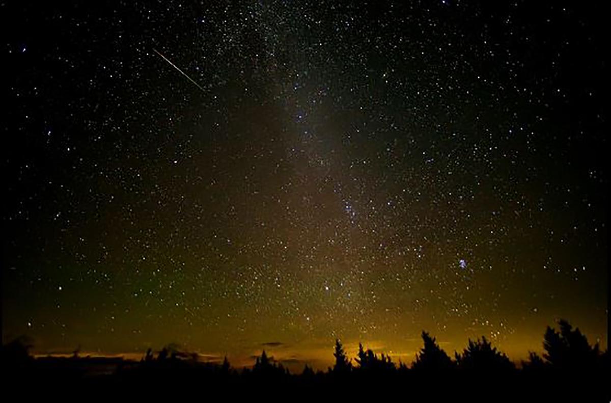 A shooting star can be seen darting through a dramatic night sky during the annual Perseid meteor shower in Spruce Knob, West Virginia, United States. (Bill Ingalls/NASA)